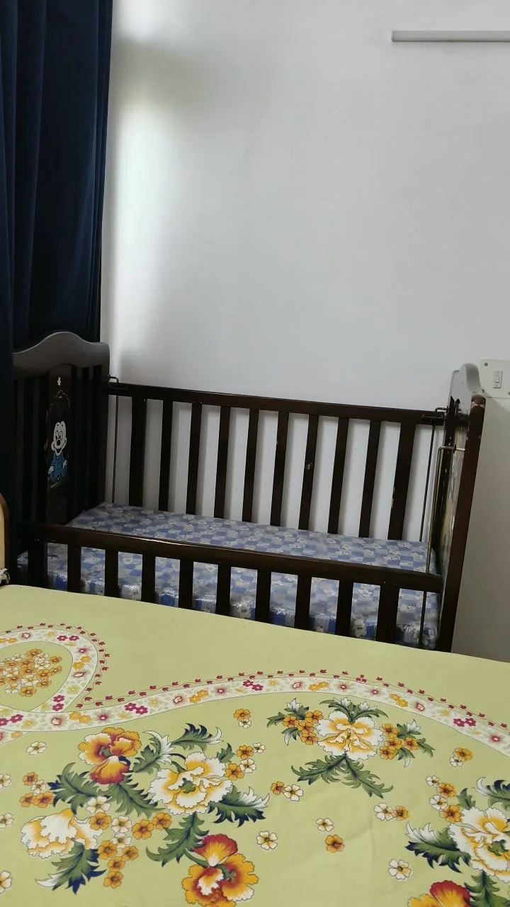 Toddler cot. One side retractable. goes up and down. has wheels and cartoons painted on it. — photo 2